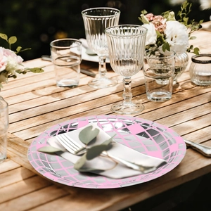 Pink and silver geometric disco mirror party plates set on a festive outdoor wooden table