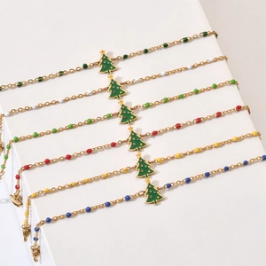 Set of six gold stainless steel beaded bracelets with colorful Christmas tree charms
