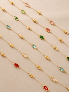 Detail of 18K gold plated chain with multi-color teardrop stones and metal beads