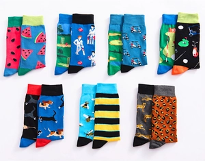 Detailed view of seven pairs of cotton socks featuring assorted animal and fruit patterns