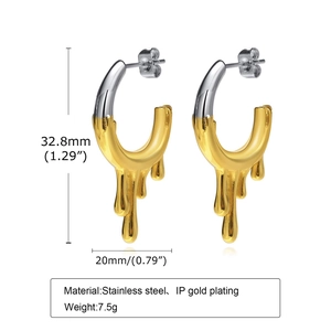 Detail of C-shaped flowing teardrop earrings in two-tone gold and silver stainless steel