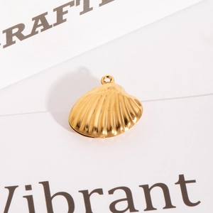 Detailed close-up of a golden seashell pendant with a textured finish and top ring