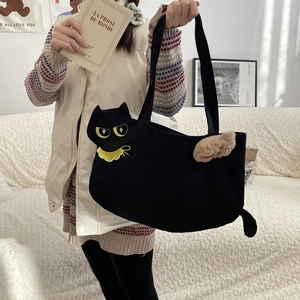 Close-up of black cat tote bag featuring 3D ears, tail, embroidery, and plush charm