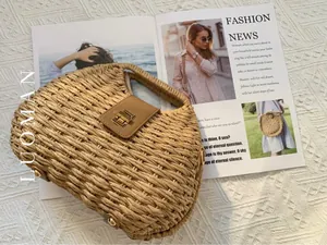 Close-up of semi-circle straw bag with brown leather flap and golden twist lock detail