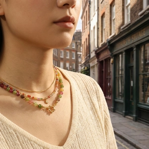 Ethnic style colorful gemstone layered necklace with a sun pendant and gold circle clasp