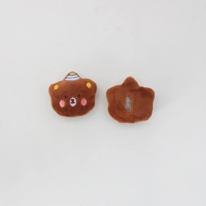 Detailed front and back view of brown plush bear head with embroidery and party hat
