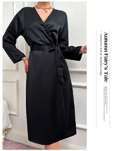 Close-up of black satin silk wrap robe with long sleeves and elegant waist tie belt