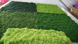 Macro view of various green faux moss turf textures and different color shades