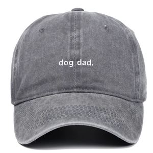 Close-up of white Dog Dad embroidery on a dark grey washed cotton baseball cap