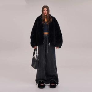 Black faux fur jacket and grey wide-leg cargo pants with a gothic cross handbag