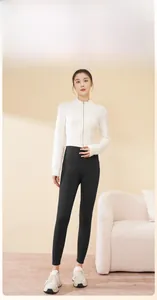Close-up of high-waist thermal yoga leggings paired with stylish athletic knitwear