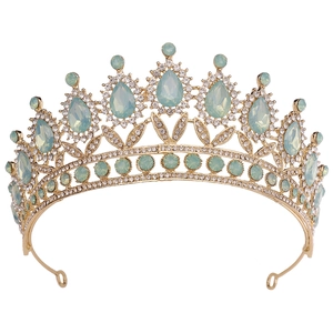 Detail of vintage gold crown with mint green crystals and white rhinestones