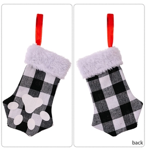 Front and back detail of black and white plaid cat paw Christmas stocking with faux fur trim