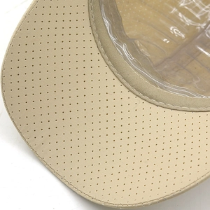 Macro shot of breathable laser-cut vents and precise stitching on khaki baseball cap
