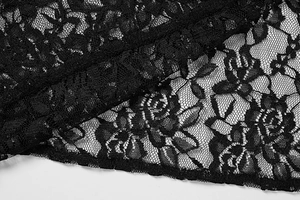 Gros plan sur la dentelle florale noire avec des bords festonnés et texture en maille