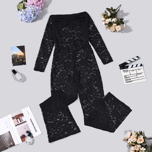 Flat lay of black lace long sleeve jumpsuit with flare legs and floral lace texture