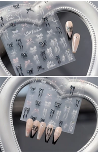 Macro detail of iridescent butterfly nail art stickers with Silk Ribbon patterns on nails