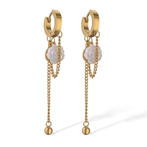 Detail of gold butterfly earrings with white rose drop and elegant long chain tassel
