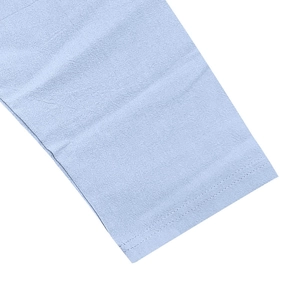 Detailed close-up showing light blue linen fabric texture and double-needle stitching quality