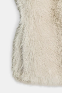 Close-up of fluffy apricot faux mink fur texture showing soft and dense material fibers