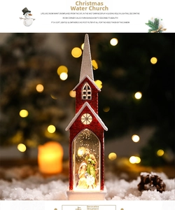 Close-up of a lit red Christmas church water globe with a Holy Family nativity scene inside