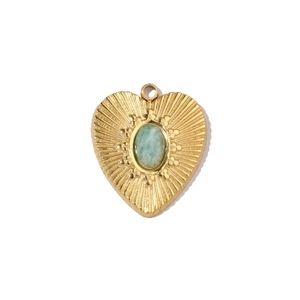 Macro view of gold heart pendant featuring a light green natural stone inlay