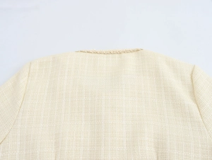 Détail du col arrière et de la texture en tweed avec des finitions effilochées