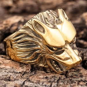 Detailed macro view of an antique gold wolf head ring with intricate metal textures