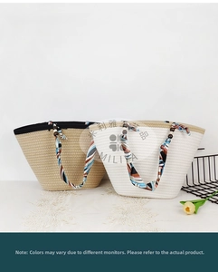 Detail of woven straw tote bag featuring silk scarf handles and decorative wooden beads