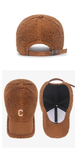 Detail of brown teddy fleece baseball cap featuring white C embroidery and adjustable strap