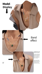 Model wearing multi-color beaded necklaces with malachite and gold heart pendants