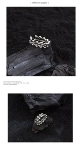 Detailed views of irregular silver heart ring with vintage gothic texture on black sand