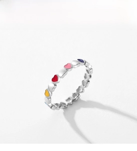 Macro detail of S925 sterling silver ring with colorful heart enamel inlays and a sleek band