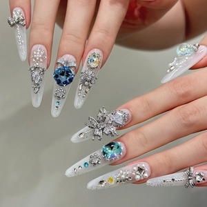 Luxury Stiletto press-on nails with ice blue crystals and silver bow decorations