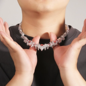 Silver dragon claw necklace with red gemstones worn by a male model for hip-hop style