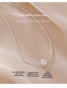 Detailed macro view of freshwater pearl necklace with silver chain on champagne silk fabric