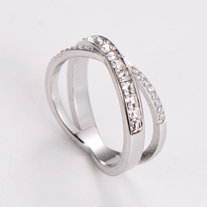 Macro detail of X-shaped stainless steel ring with princess-cut cubic zirconia stones