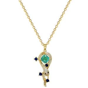 Golden snake necklace with green emerald-cut stone and blue accents on white background