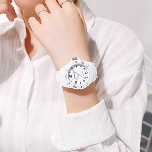 Close-up of a white quartz watch with silicone strap worn on a wrist for children