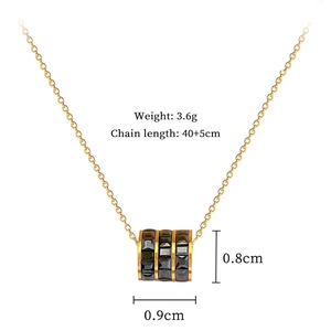 Detail shot of golden necklace with black cylinder pendant showing size 0.9cm and weight 3.6g