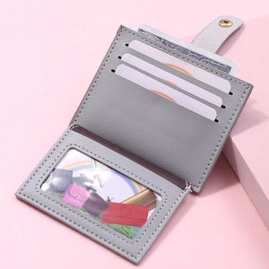 Macro view of grey faux leather card wallet with multiple slots and clear ID window