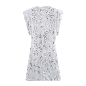 Detail of silver sequined mini dress featuring padded shoulders and shimmering fabric