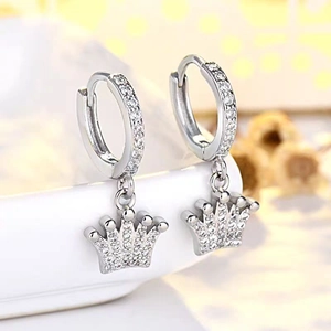 Macro detail of silver crown earrings with sparkling pavé cubic zirconia accents
