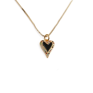 Detailed close-up of golden heart pendant with black enamel and multi-color gems