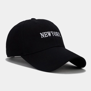 Dettaglio del ricamo bianco NEW YORK su un cappellino da baseball in cotone nero con visiera