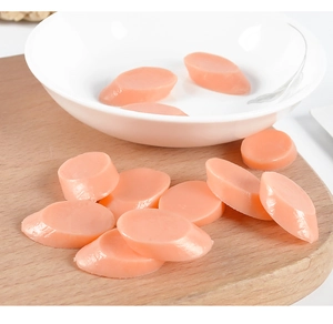 Detailed view of realistic PVC miniature ham slices on a wooden board for dollhouse play