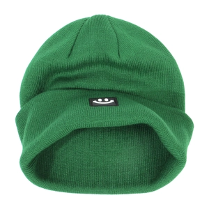 Close-up of green knitted beanie featuring a black rectangular smiley face patch detail