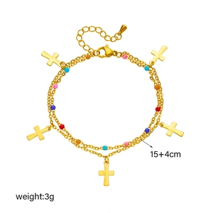 Detailed view of a gold cross bracelet with colorful beads and adjustable 15+4cm chain