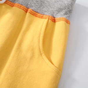Kids' yellow knit shorts with grey contrast waistband and orange stitched side pocket