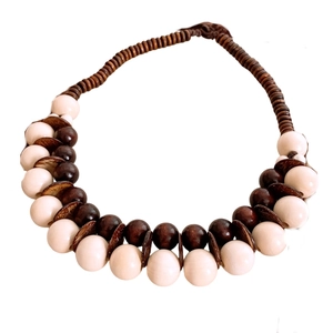 Collana bohémien fatta a mano con perle in legno e guscio di cocco su sfondo bianco